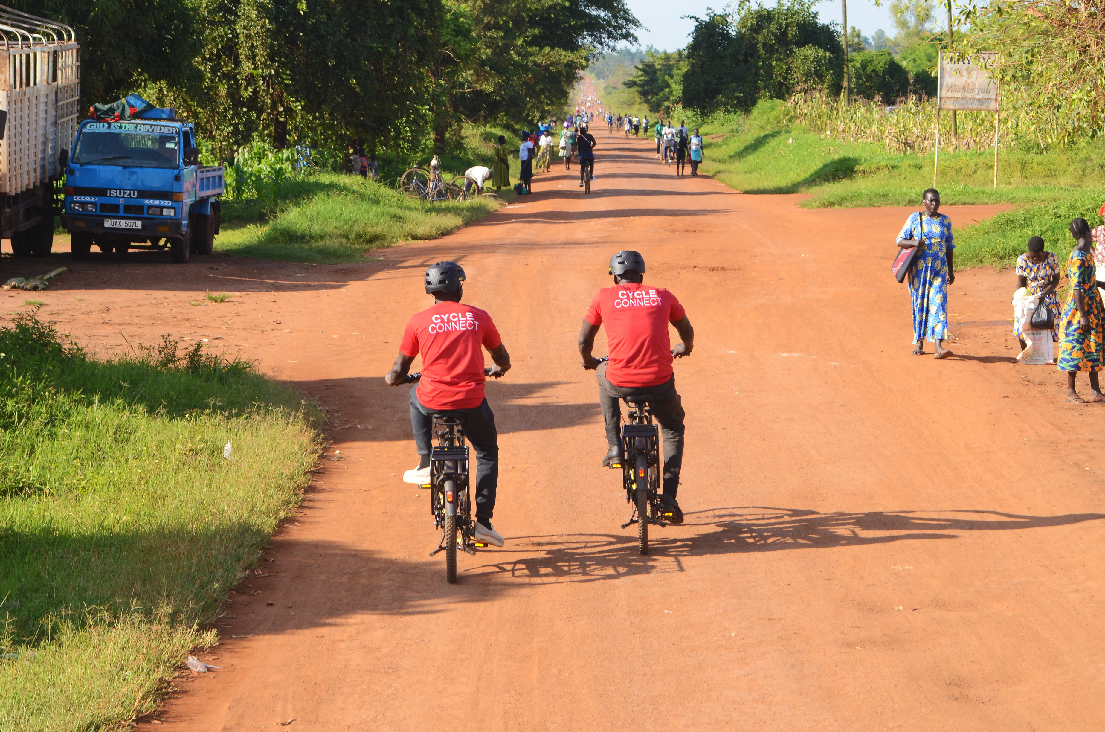 Cycle Connect staff riding electric bicycles on a rural road